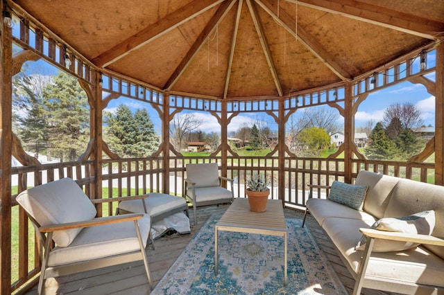wooden deck with an outdoor living space and a gazebo
