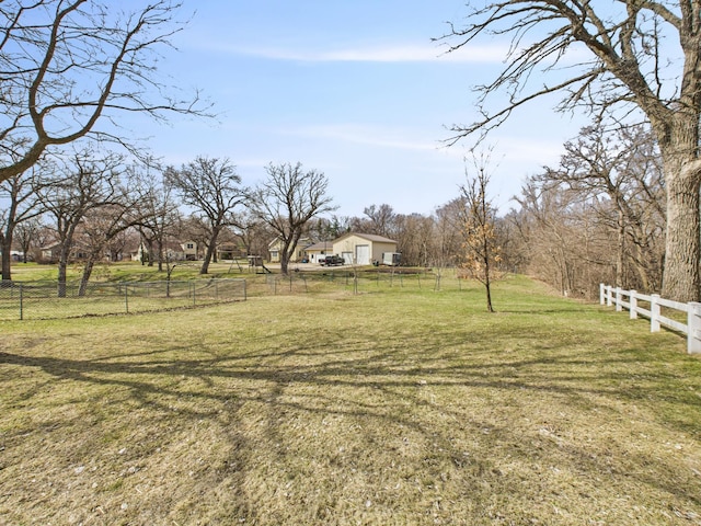 view of yard featuring a rural view and fence