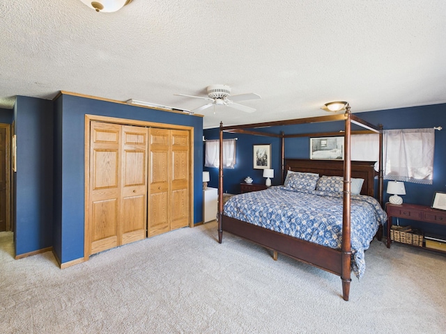 carpeted bedroom featuring a textured ceiling and ceiling fan