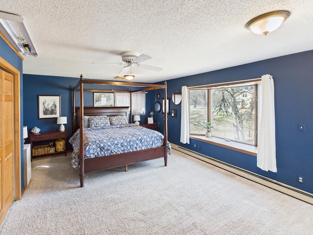 bedroom featuring carpet flooring, baseboard heating, a textured ceiling, and ceiling fan