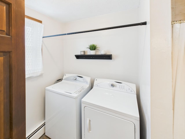laundry area with independent washer and dryer, a baseboard heating unit, and laundry area
