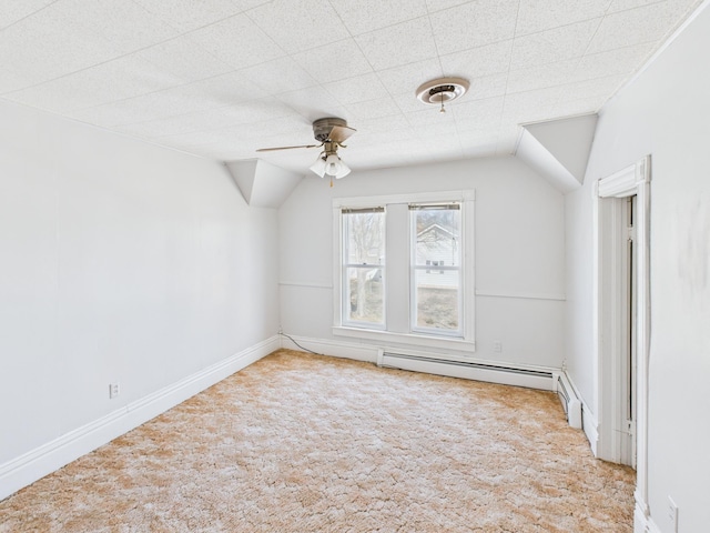 bonus room featuring a baseboard heating unit, carpet flooring, a ceiling fan, and vaulted ceiling