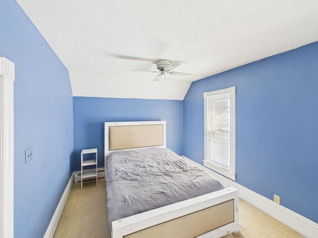 carpeted bedroom featuring baseboards, a baseboard radiator, ceiling fan, a textured ceiling, and vaulted ceiling
