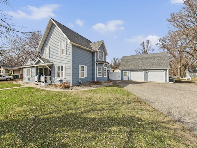 view of home's exterior featuring a garage, a yard, a porch, and an outdoor structure