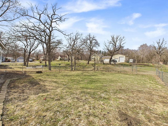 view of yard with a garage and fence