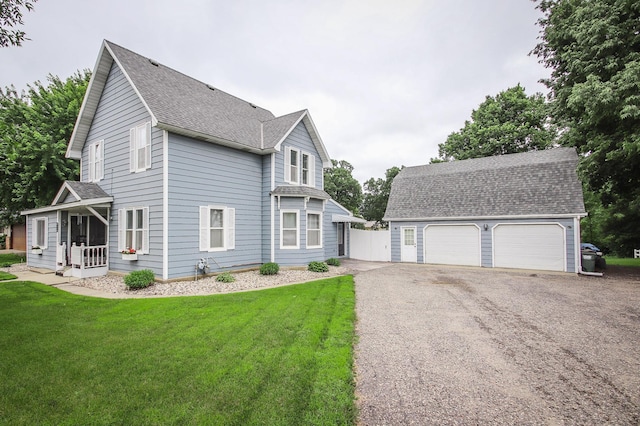664 Business 23 W, Paynesville, MN 56362 - view of side of home featuring a shingled roof, a yard, a garage, an outdoor structure, and a porch