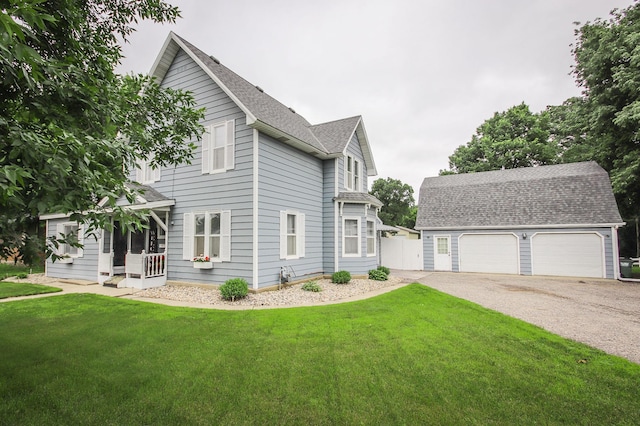 664 Business 23 W, Paynesville, MN 56362 - view of side of property featuring an outdoor structure, a shingled roof, a garage, and a lawn