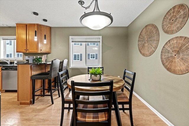 6491 Regency Ln, Eden Prairie, MN 55344 - dining room featuring light wood-type flooring and a textured ceiling