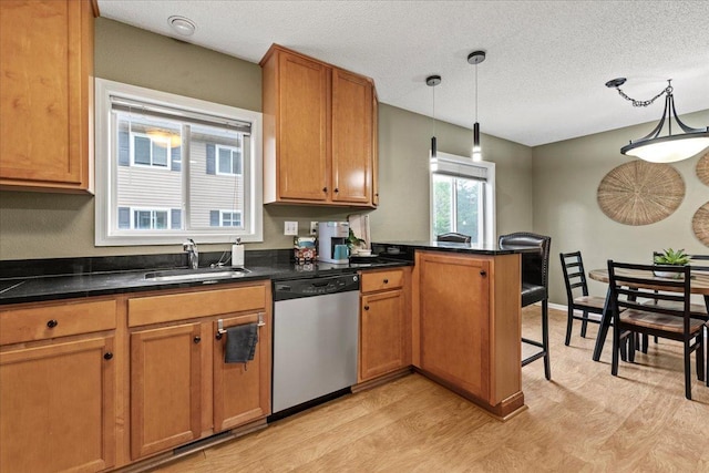 6491 Regency Ln, Eden Prairie, MN 55344 - kitchen with stainless steel dishwasher, light wood-style flooring, a peninsula, pendant lighting, and brown cabinets