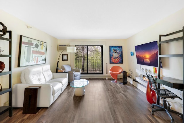 living room featuring wood finished floors and a wall mounted air conditioner