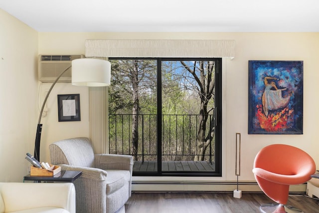 living area with wood finished floors and a wall mounted air conditioner