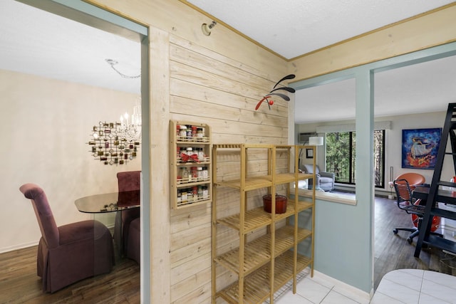 interior space featuring wood finished floors, wood walls, and baseboards