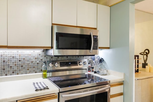 kitchen with stainless steel appliances, light countertops, and tasteful backsplash