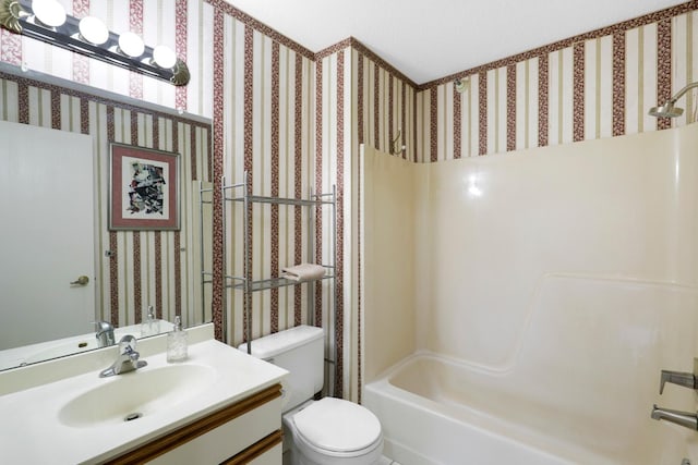 full bath featuring toilet, vanity, and bathtub / shower combination