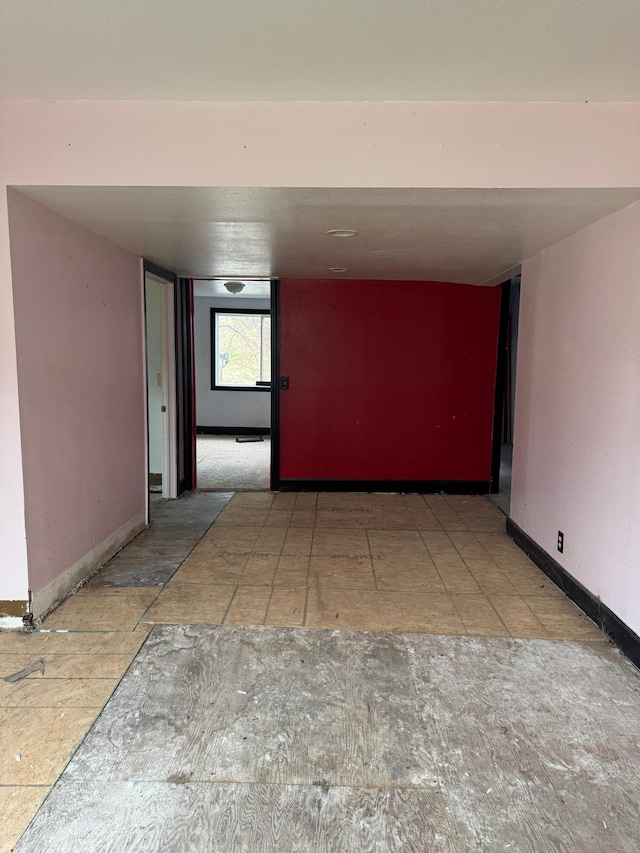 hall featuring baseboards