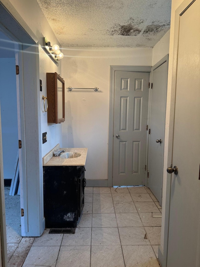 bathroom featuring vanity and a textured ceiling