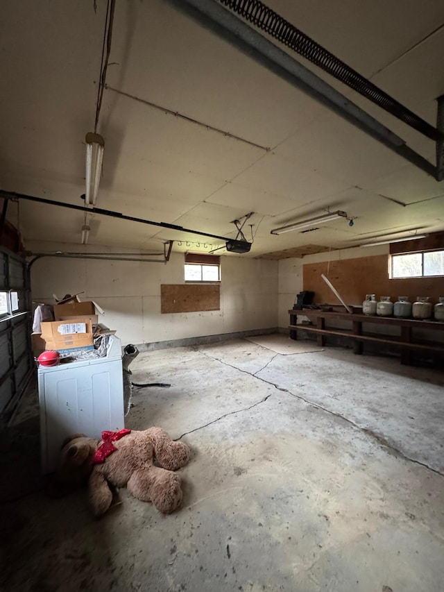garage featuring a garage door opener and washer / clothes dryer