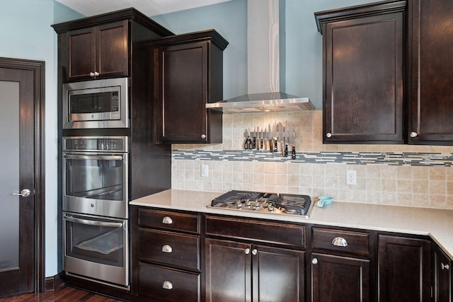 3209 Symphony Ct, Chaska, MN 55318 - kitchen with wall chimney range hood, appliances with stainless steel finishes, dark wood-style flooring, and decorative backsplash