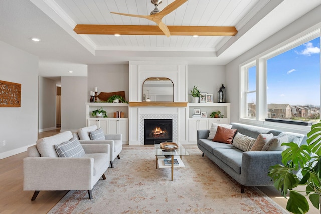 living room featuring wood ceiling, beam ceiling, a tile fireplace, recessed lighting, and wood finished floors