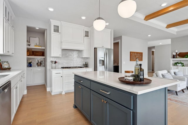 kitchen featuring white cabinetry, light wood-style flooring, stainless steel appliances, beam ceiling, and gray cabinets