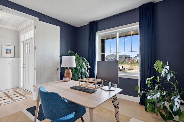 office featuring ornamental molding, a wealth of natural light, and light wood-style floors