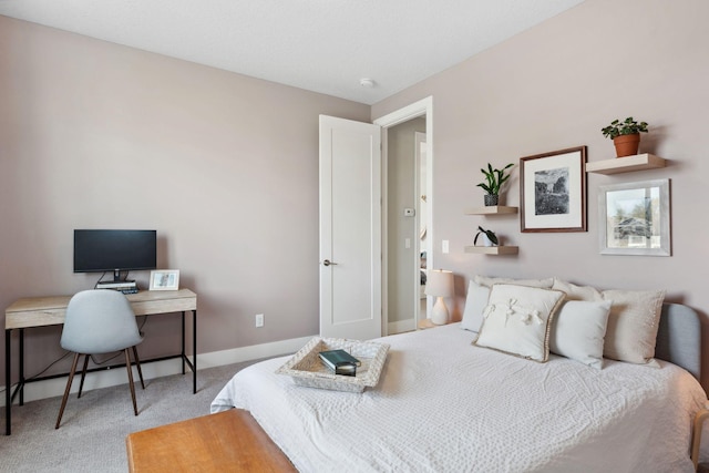 bedroom featuring baseboards and carpet