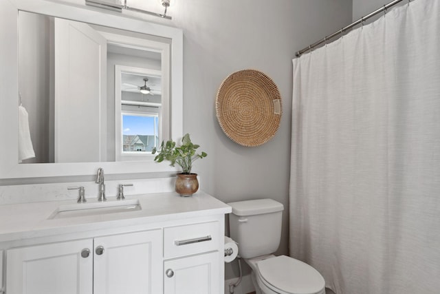 bathroom featuring toilet, a ceiling fan, and vanity