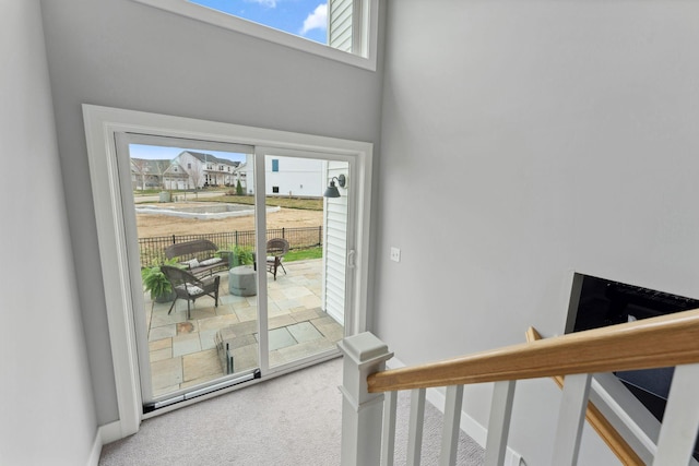 interior space with baseboards, a wealth of natural light, and carpet