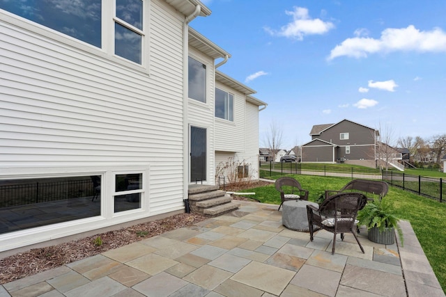 view of patio featuring fence, entry steps, and a residential view