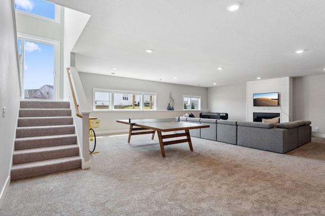 playroom with carpet, a large fireplace, and recessed lighting