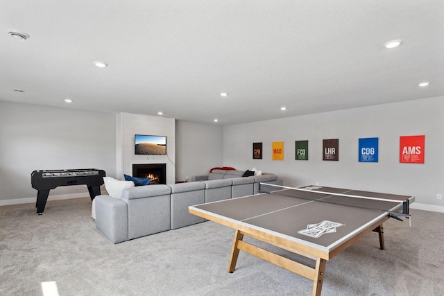 rec room featuring recessed lighting, baseboards, carpet, and a fireplace