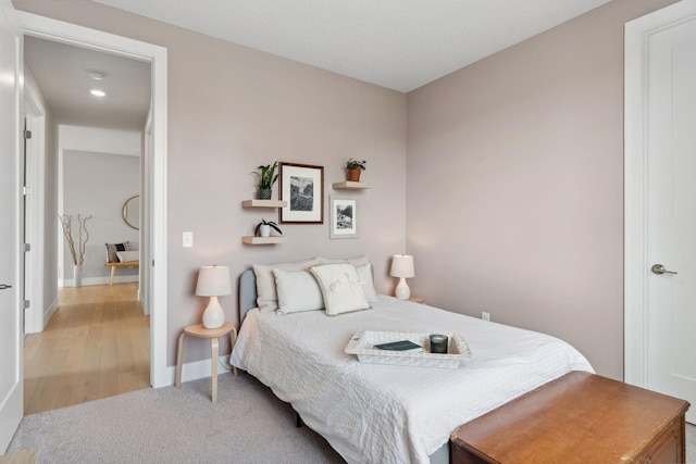 bedroom featuring wood finished floors and baseboards