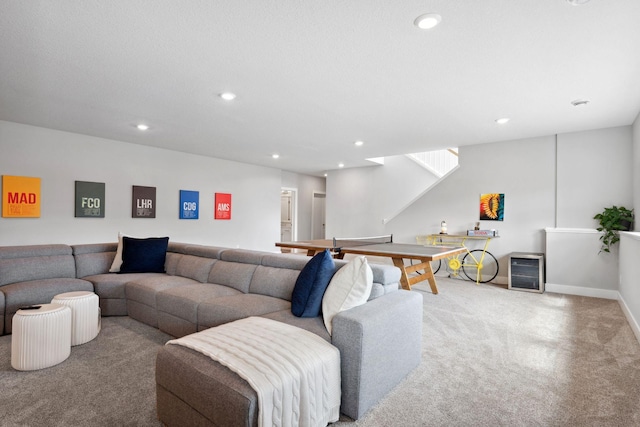 carpeted living room with recessed lighting and baseboards