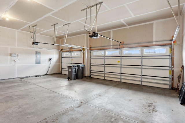 garage featuring a garage door opener and electric panel