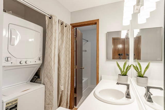 full bath featuring stacked washer and dryer, shower / bath combo, and vanity
