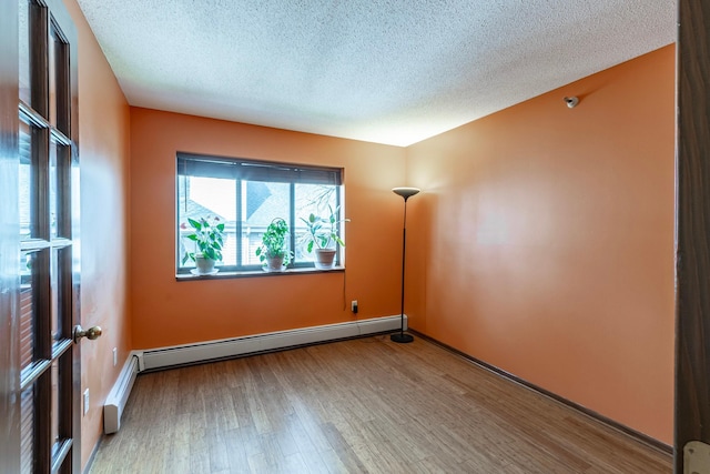 7631 Edinborough Way Unit 5319, Edina, MN 55435 - empty room featuring wood finished floors, a textured ceiling, and baseboard heating