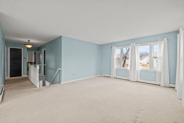 unfurnished room featuring a baseboard radiator, carpet, baseboard heating, and baseboards