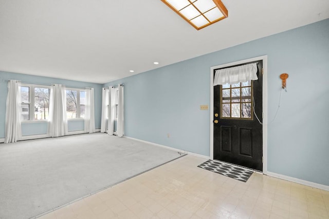 carpeted entryway featuring recessed lighting and baseboards