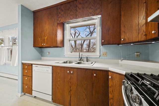 kitchen with exhaust hood, gas range, baseboard heating, dishwasher, and a sink
