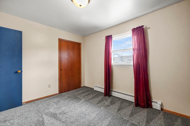 unfurnished bedroom with dark colored carpet and baseboards