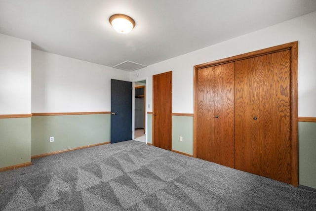 unfurnished bedroom featuring a closet, carpet flooring, and baseboards