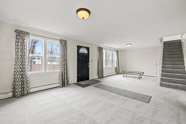 carpeted entrance foyer with ornamental molding and stairway