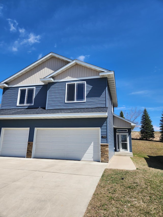 view of front of home with concrete driveway, a garage, and stone siding