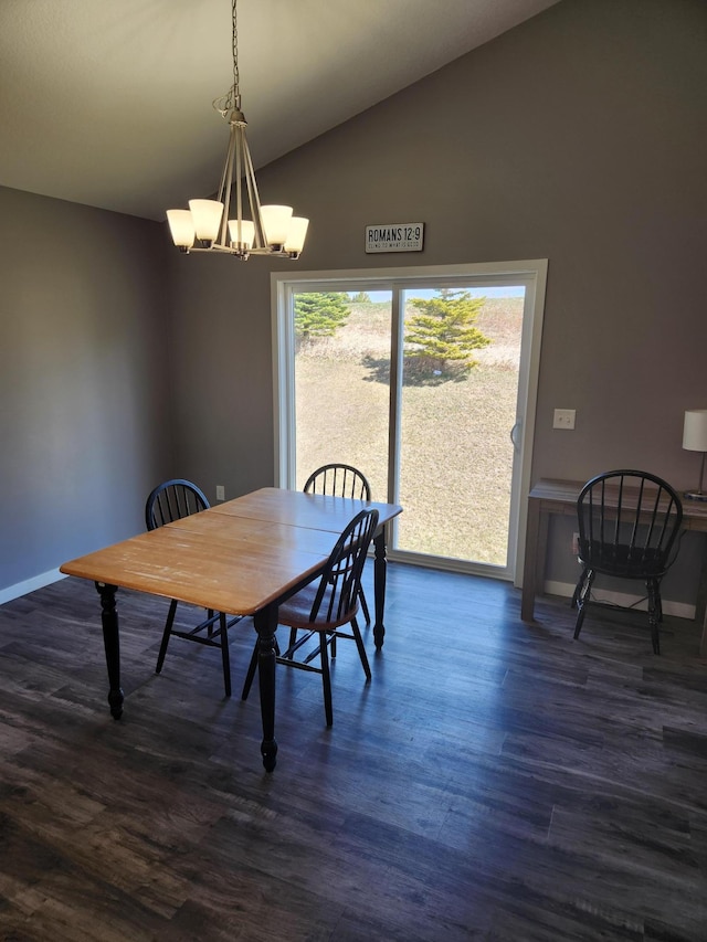 dining space featuring dark wood finished floors, baseboards, an inviting chandelier, and lofted ceiling