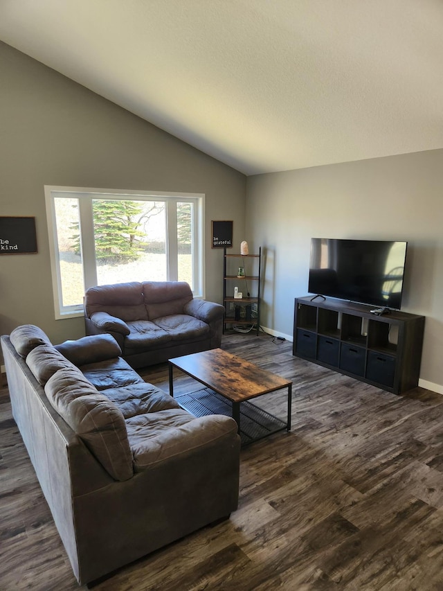 living room featuring baseboards, vaulted ceiling, and wood finished floors