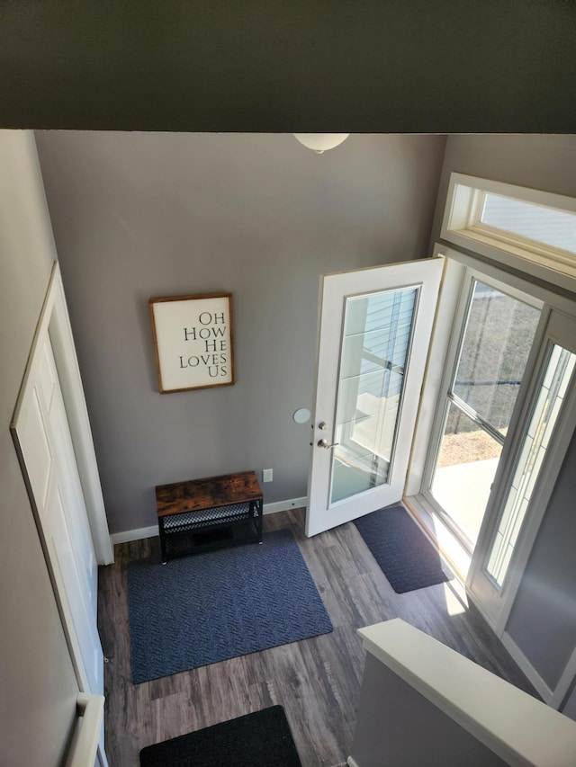 doorway featuring baseboards and dark wood finished floors