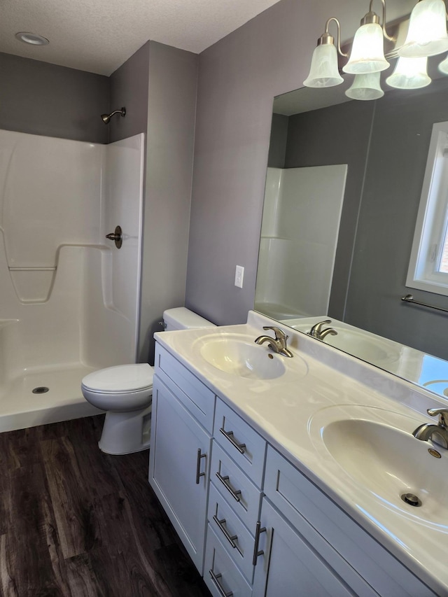 bathroom with a sink, toilet, and wood finished floors