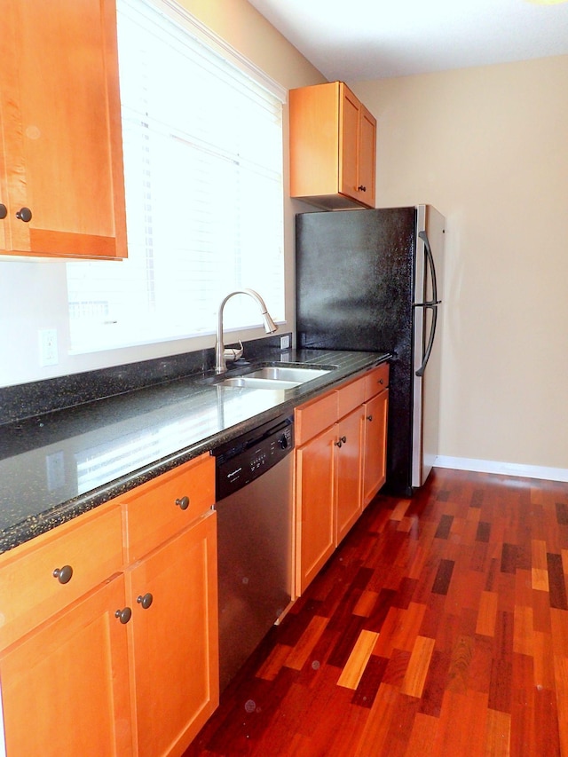 1070 Grandview Ct NE Unit 413, Columbia Heights, MN 55421 - kitchen featuring dark stone counters, a sink, dark wood finished floors, baseboards, and appliances with stainless steel finishes