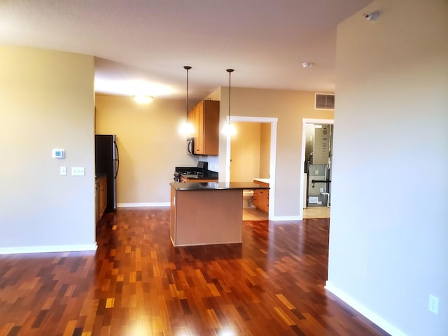 1070 Grandview Ct NE Unit 413, Columbia Heights, MN 55421 - kitchen featuring dark countertops, baseboards, appliances with stainless steel finishes, dark wood-type flooring, and visible vents