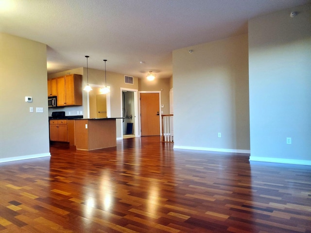 1070 Grandview Ct NE Unit 413, Columbia Heights, MN 55421 - unfurnished living room with dark wood finished floors, visible vents, and baseboards